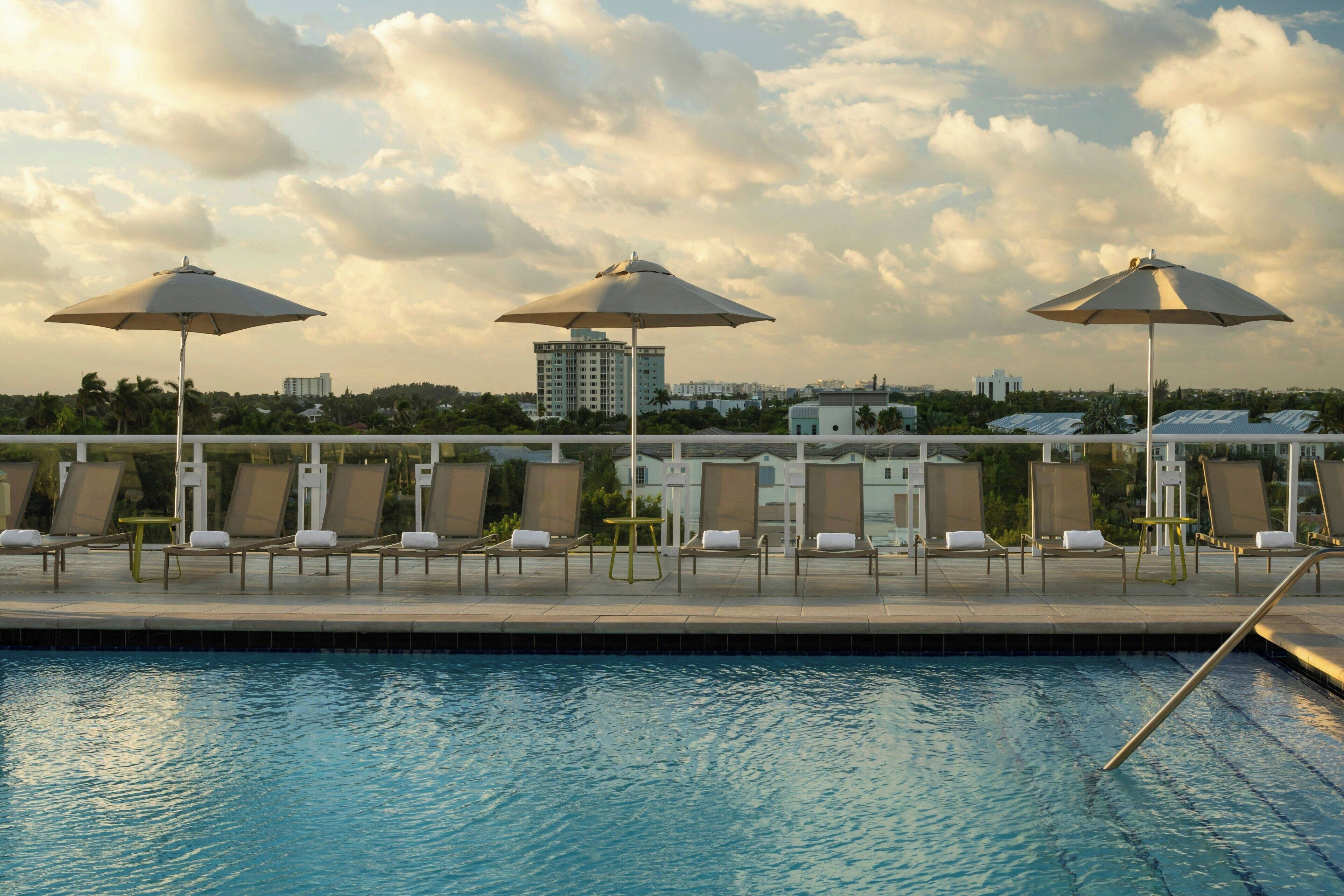 outdoor pool, open 6:00 am to 10:00 pm, pool umbrellas, pool loungers