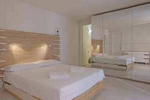 2 habitaciones, escritorio y tabla de planchar con plancha