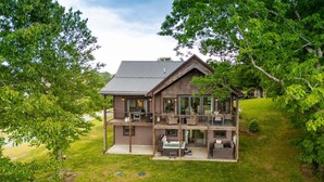 A two-story house with a balcony, a deck, and a hot tub. - Upscale Home near Blue Ridge Parkway (Boone)