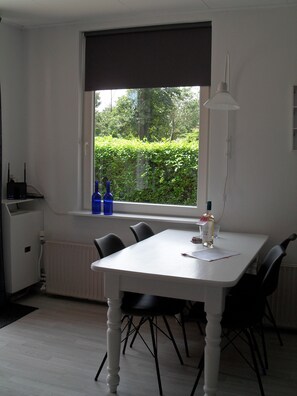 Dining - Rest, fireplace, sea, that is what our holiday bungalow can offer you (Baarland)