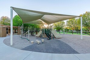 A playground with slides, climbing structures, and a shaded area. - MONTHLY SPECIAL Patrick Place Spacious 3 BR Home Golf/Shopping/Gilbert (Gilbert)