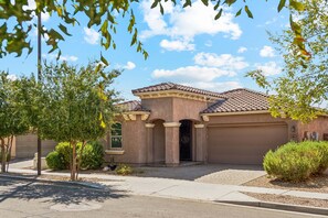 A residential house with a tiled roof, a garage, and a driveway. - MONTHLY SPECIAL Patrick Place Spacious 3 BR Home Golf/Shopping/Gilbert (Gilbert)
