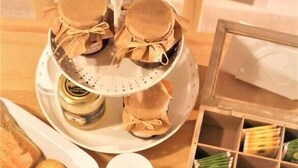 A breakfast setting with bread, pastries, and coffee. - B&B Torre Castellina (Piazza Armerina)