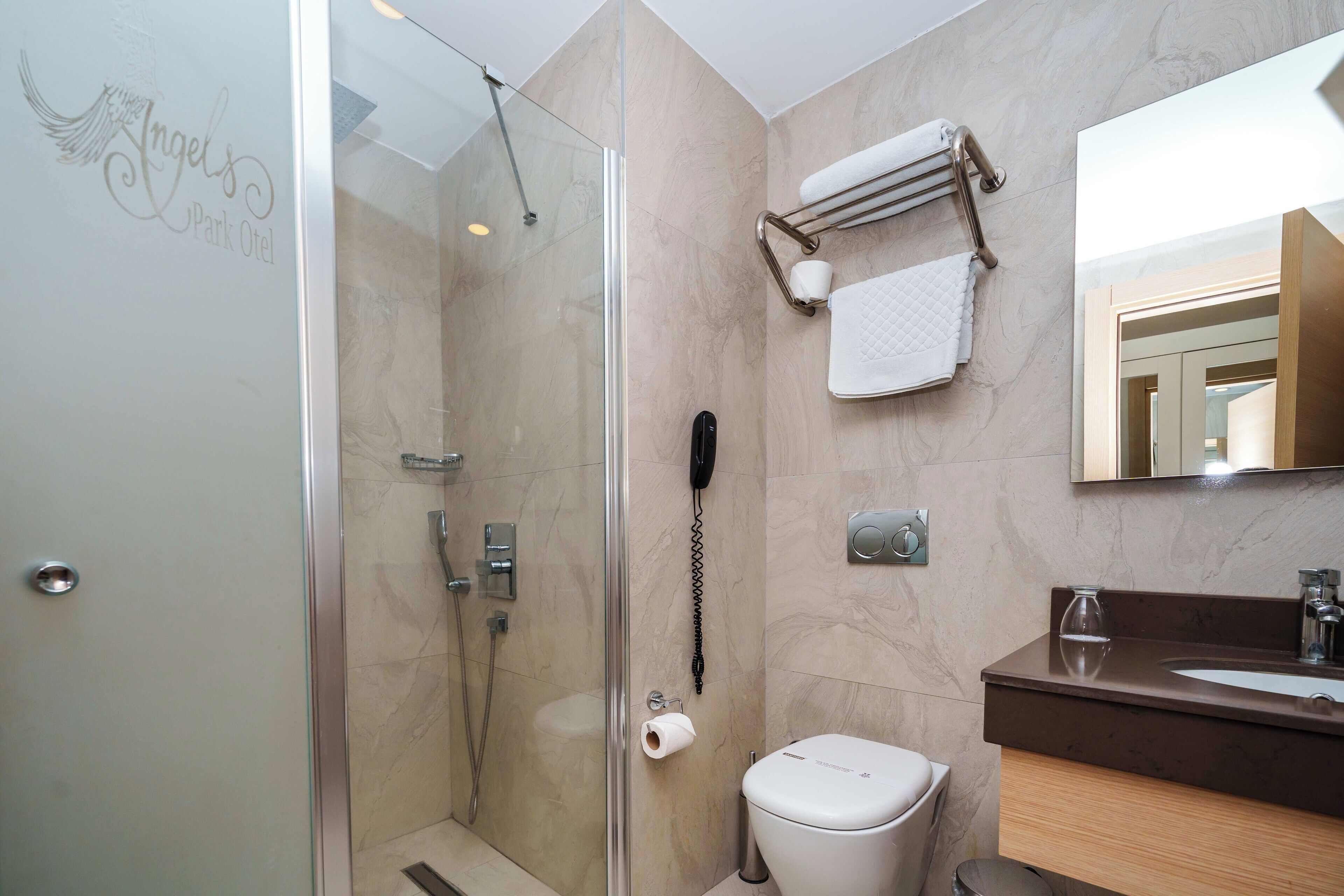 shower, hair dryer, slippers, towels