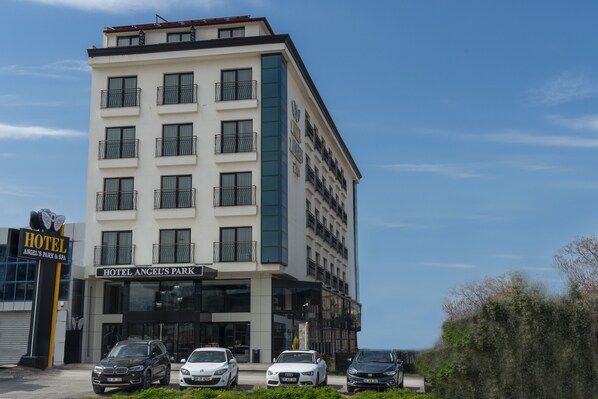 A multi-story hotel with balconies, a sign reading "Hotel Angel's Park," and several cars parked in front. - Angel's Park Hotel (Denizli)