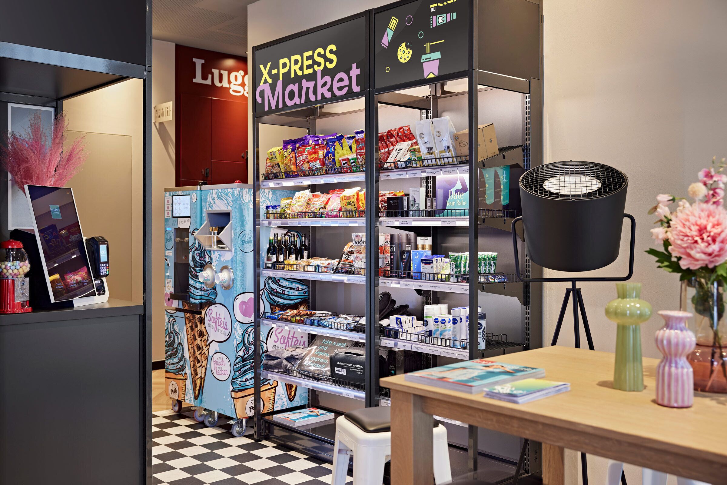 A X-Press Market with shelves stocked with snacks, beverages, and other items.