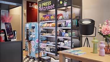 A X-Press Market with shelves stocked with snacks, beverages, and other items.