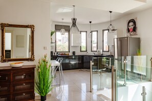 Exclusive Apartment | Private kitchen | Full-size fridge, microwave, oven, stovetop