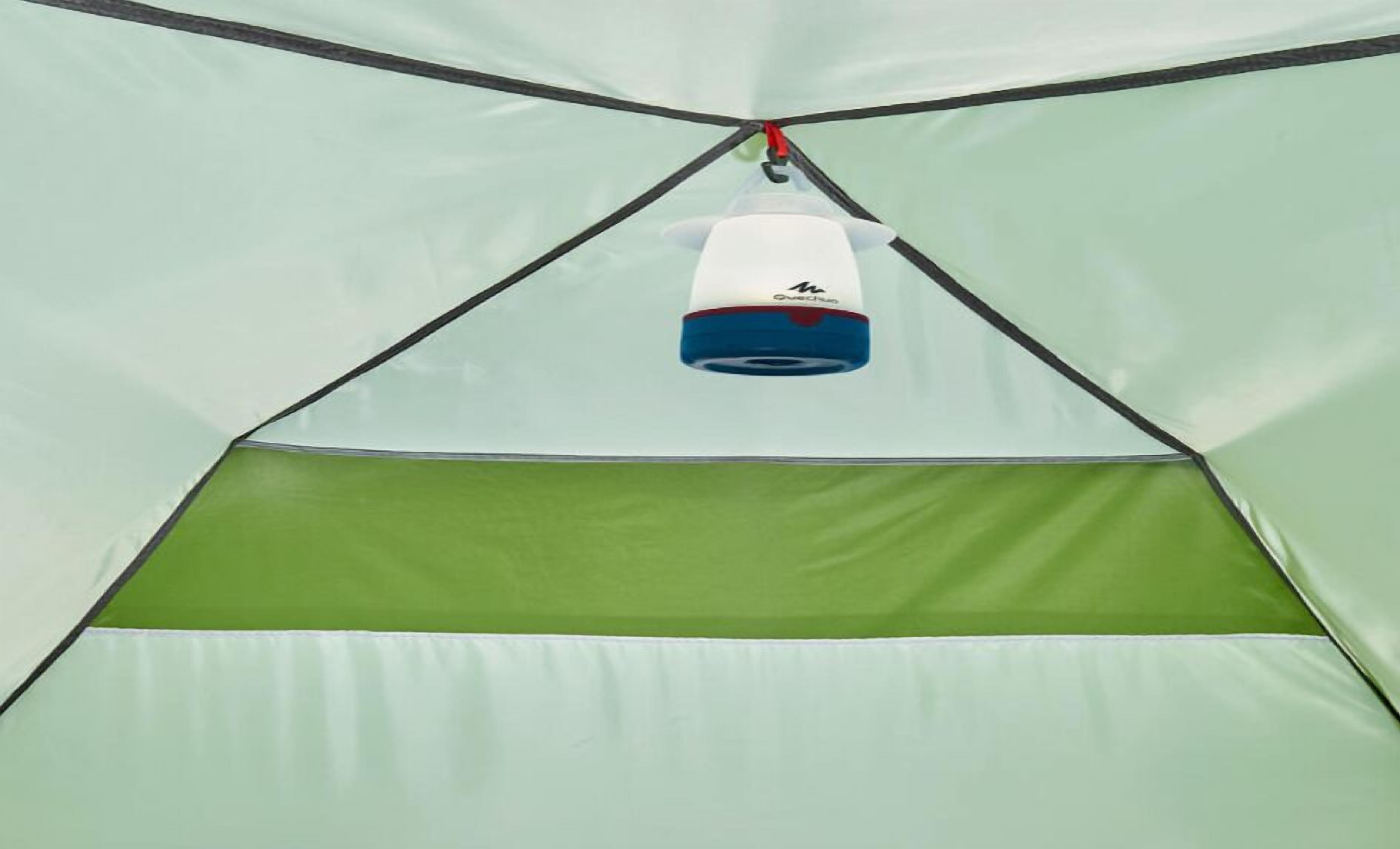 A tent with a green interior and a hanging object.