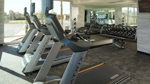 A gym with treadmills, dumbbells, and a motivational quote on the wall. - Fairfield Inn & Suites by Marriott Riverside Moreno Valley (Moreno Valley)