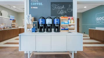 A coffee station with dispensers, a sign reading 'MUST HAVE COFFEE,' and a wall with 'Fresh Coffee' written on it.