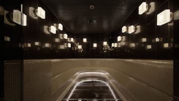 Bany amb llums il·luminades i revestiment de rajola, amb una il·luminació suau.