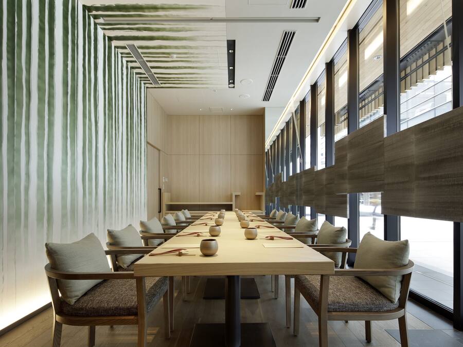 A conference room with a long table, chairs, and a modern design.