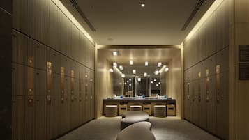 Guests can store their belongings in the locker room, which features a large mirror and a counter with amenities.