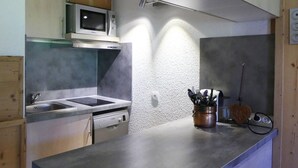 A modern kitchen with stainless steel appliances, a microwave, and a sink.