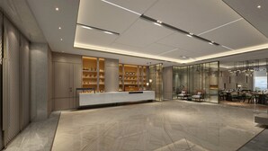 A modern reception area with a marble floor, a reception desk, and a seating area with tables and chairs. - Holiday Inn Express Changzhou Xinbei by IHG (Changzhou)