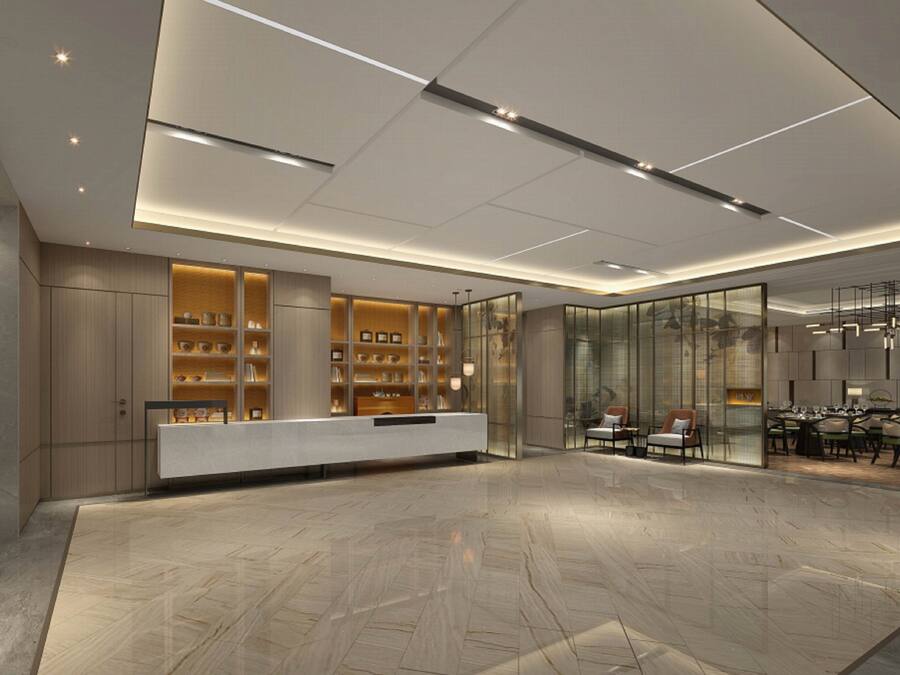 A modern reception area with a marble floor, a reception desk, and a seating area with tables and chairs.