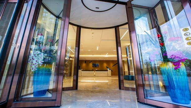 A hotel entrance with glass doors, a reception desk, and a modern interior. - Holiday Inn Express Changzhou Xinbei by IHG (Changzhou)