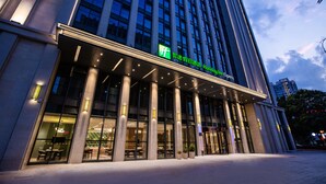 A modern building with a Holiday Inn Express sign, large windows, and a well-lit entrance area. - Holiday Inn Express Changzhou Xinbei by IHG (Changzhou)