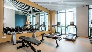 A gym with treadmills, dumbbells, and a bench. - Holiday Inn Express Changzhou Xinbei by IHG (Changzhou)