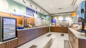 A modern breakfast area with a refrigerated display for eggs and milk, a fruit section, and a bakery counter. - Holiday Inn Express & Suites Florence-Cincinnati Airport by IHG (Florence)