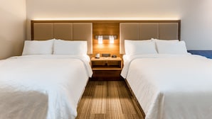 A hotel room with two beds, a wooden headboard, bedside lamps, and a nightstand with a phone and a small table. - Holiday Inn Express & Suites Florence-Cincinnati Airport by IHG (Florence)