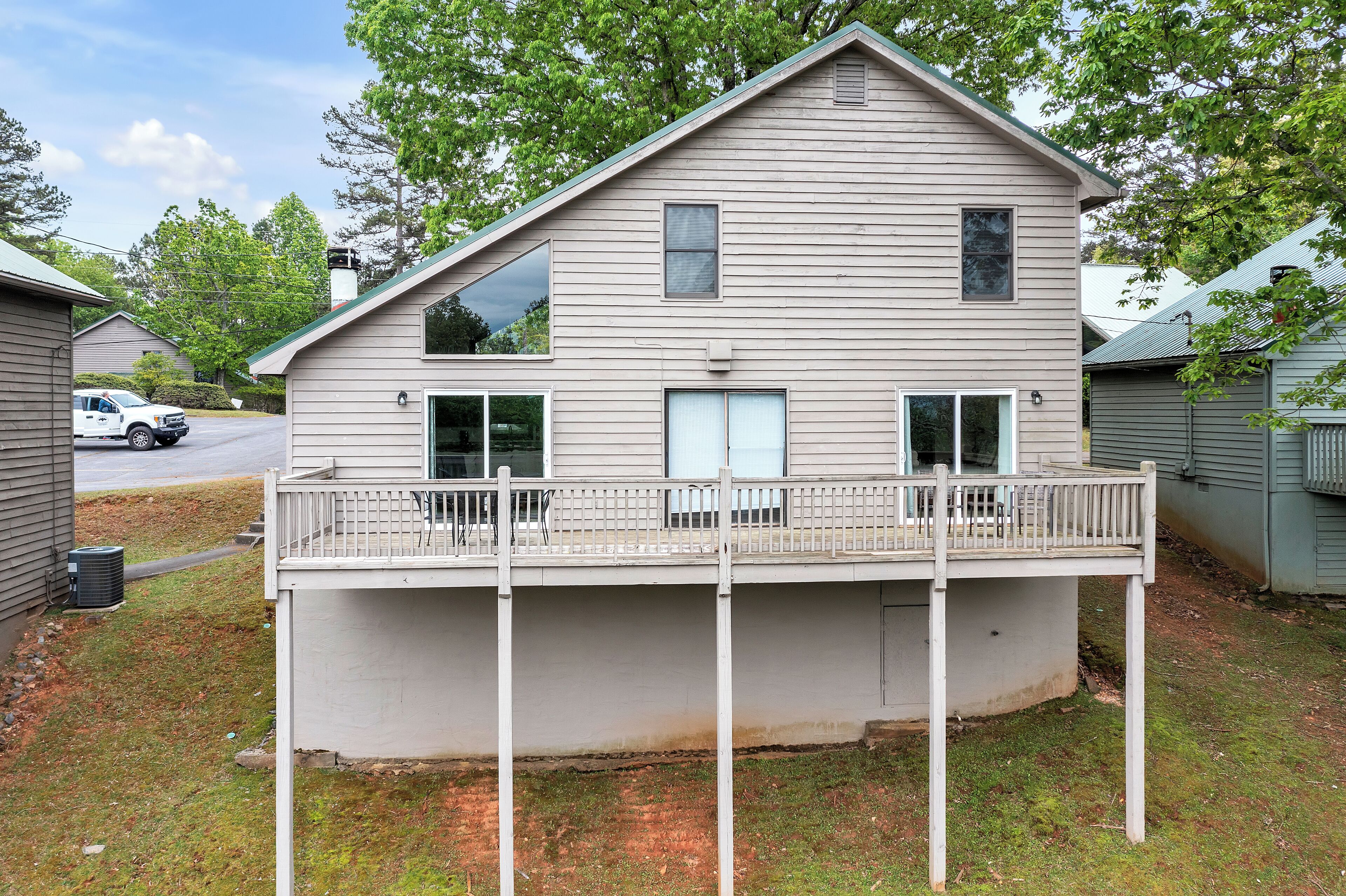 A two-story house with a balcony, a garage, and a driveway.