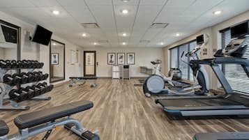 Academia com esteiras, bicicleta ergométrica e equipamentos de musculação.