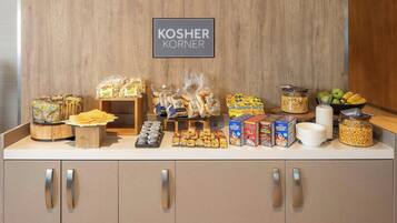 A kosher food display with various snacks and cereals.
