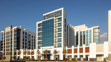 A multi-story hotel with a prominent glass facade and signage reading "HYATT PLACE".