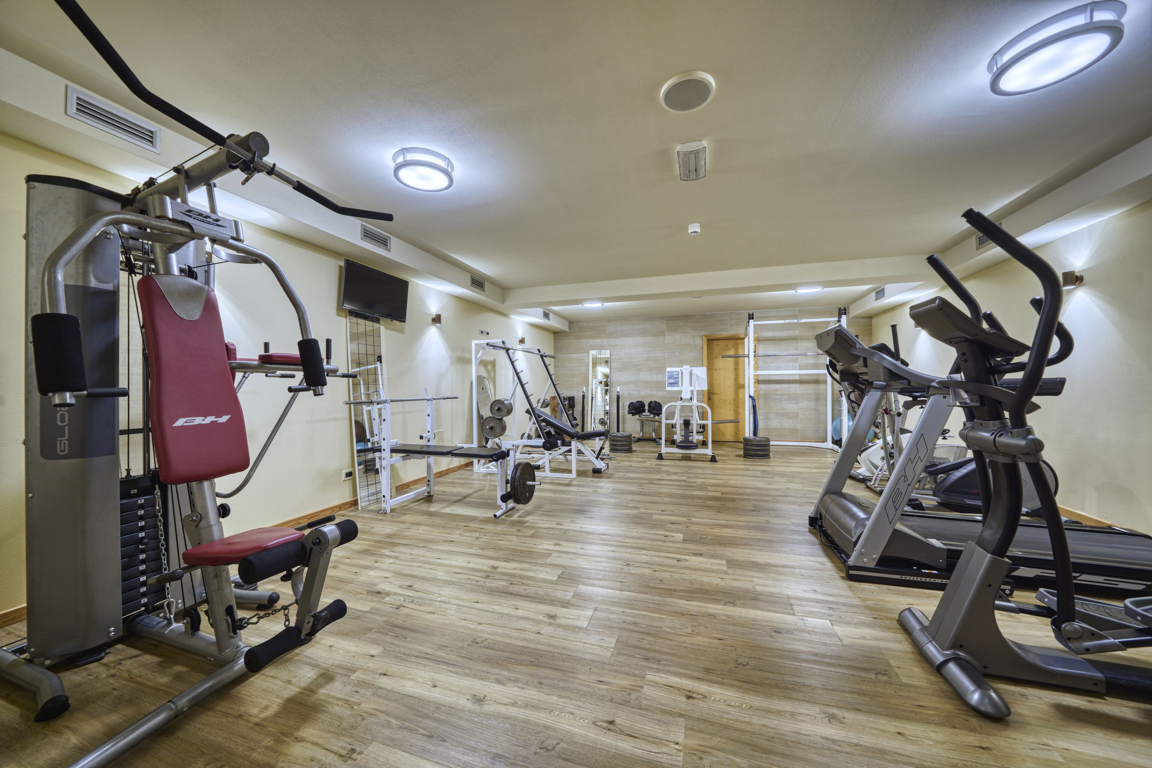 A gym with various exercise equipment, including treadmills and weight machines.