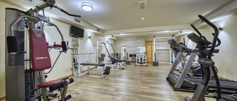 A gym with various exercise equipment, including treadmills and weight machines.