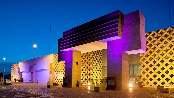 A modern building with geometric patterns and illuminated structures.