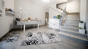A modern interior with a dining area, a staircase, and a reception desk. - Dove sorge il sole (Custonaci)