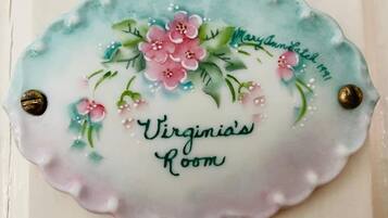 A decorative plaque with floral patterns and the text 'Virginia's Room' and 'Maryam's 1991'.