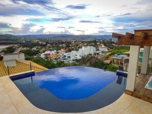 Outdoor pool, an infinity pool, pool umbrellas, pool loungers