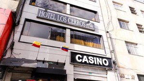 A building with a sign for 'Hotel Los Cerrros' and a 'Casino' sign below it.