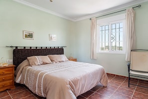 A bedroom with a bed, nightstands, a window with curtains, and artwork on the wall. - Rustic Home Close to the Beach with Pool, Terrace, Garden & Wi-Fi; Parking Available, Pets Allowed (Vejer de la Frontera)