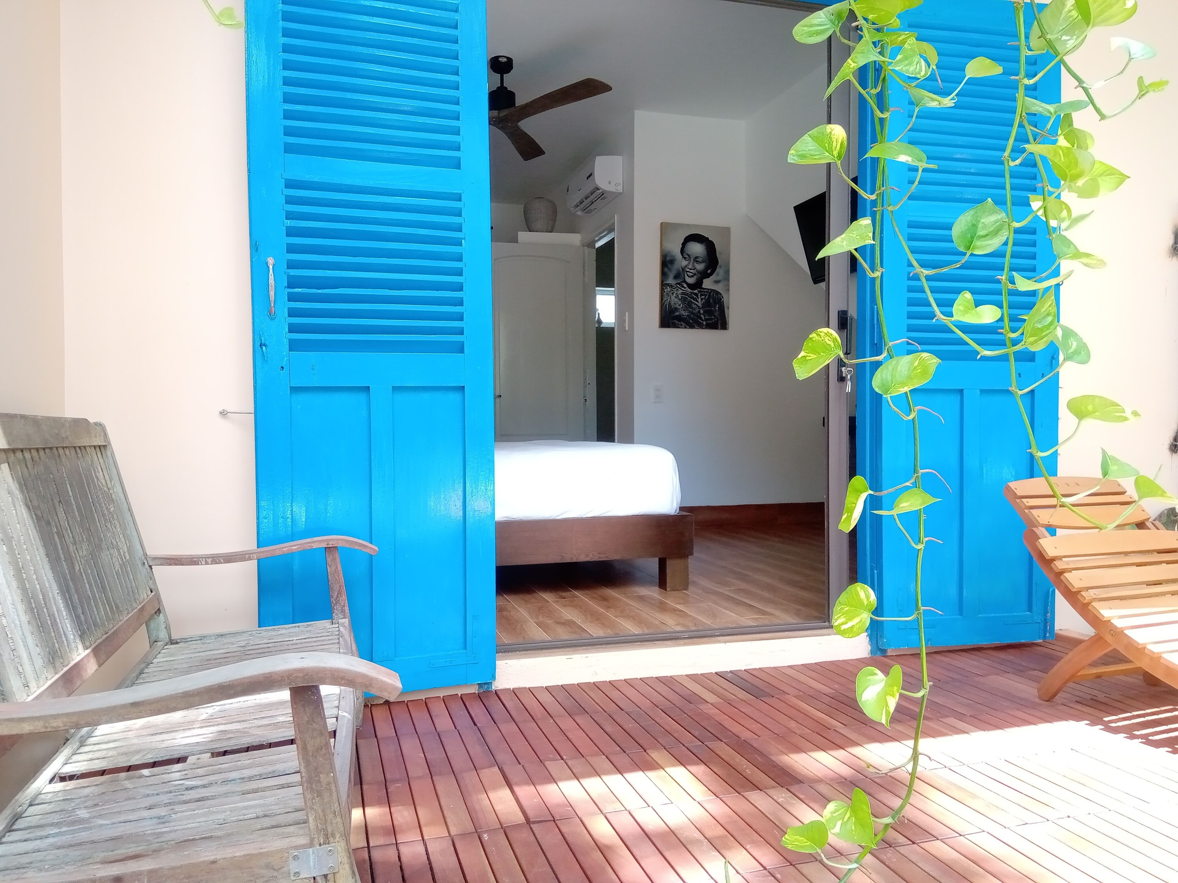 A room with a bed, a chair, and a wooden table.