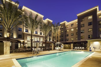 Outdoor pool, open 8:00 AM to 10:00 PM, pool umbrellas, sun loungers at Staybridge Suites Irvine-John Wayne Airport by IHG