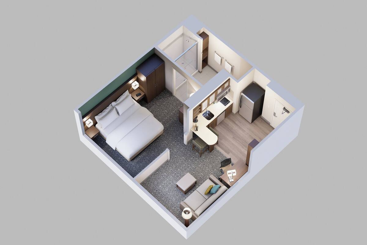 A 3D floor plan of a hotel room with a bed, a desk, a small kitchenette, a bathroom, and a seating area.