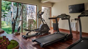 A home gym with treadmills, an elliptical, and a stationary bike. - Jungloo at Templation (Siem Reap)