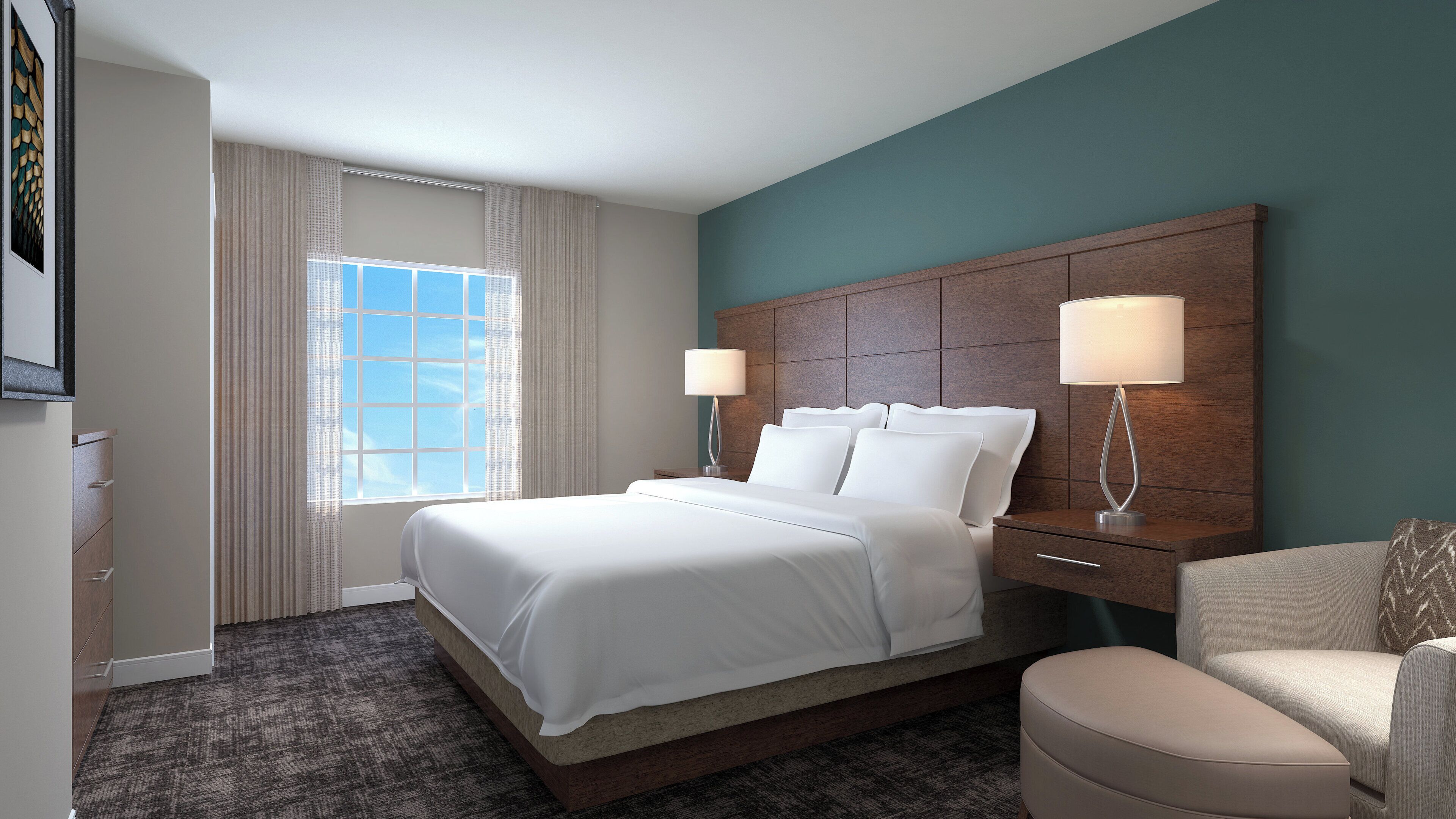 A hotel room with a large bed, two bedside lamps, a chair, a dresser, and a window with curtains.