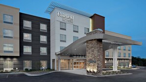 A Fairfield by Marriott hotel with a modern design, featuring a prominent entrance, a covered outdoor area, and a parking lot.