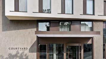 A modern building with a flat facade, large windows, and a glass entrance.