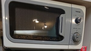 A microwave on a shelf, a kettle, a packet of instant noodles, a bowl, and a small refrigerator with a power switch. - Valentine - Adults Only (Tottori)