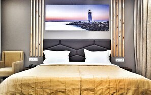Un dormitorio moderno con una cama grande, un cabecero de diseño geométrico, una pintura de un faro y un panel de madera decorativo.