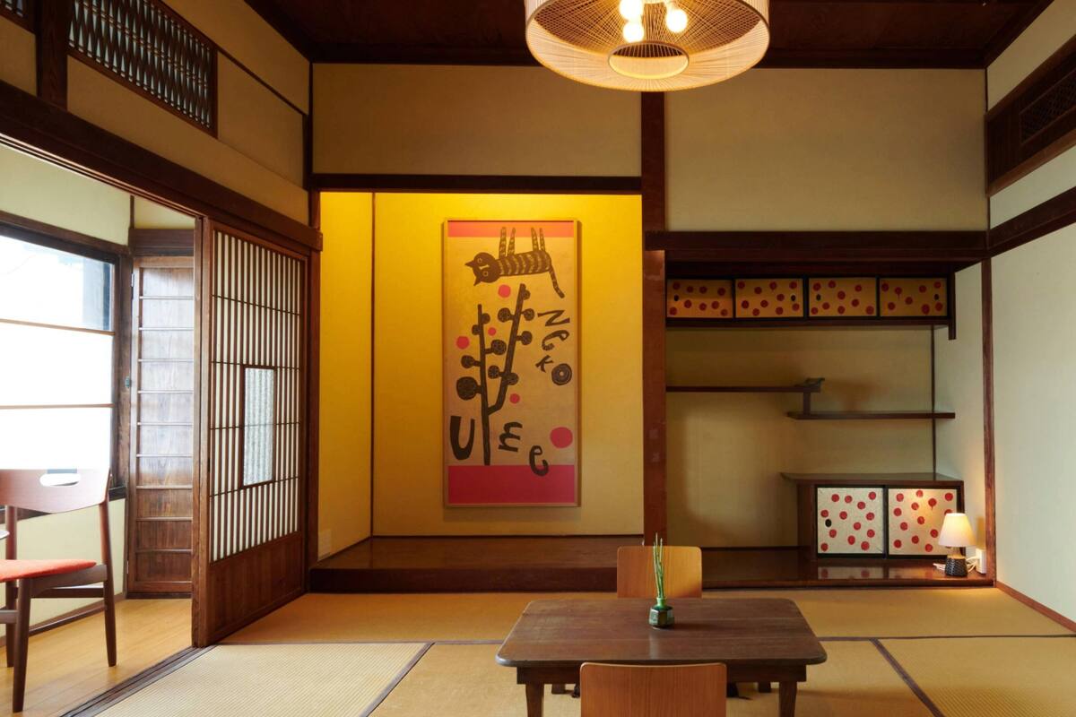 Een traditionele Japanse kamer met tatami vloerbedekking, een lage tafel en een schuifdeur.
