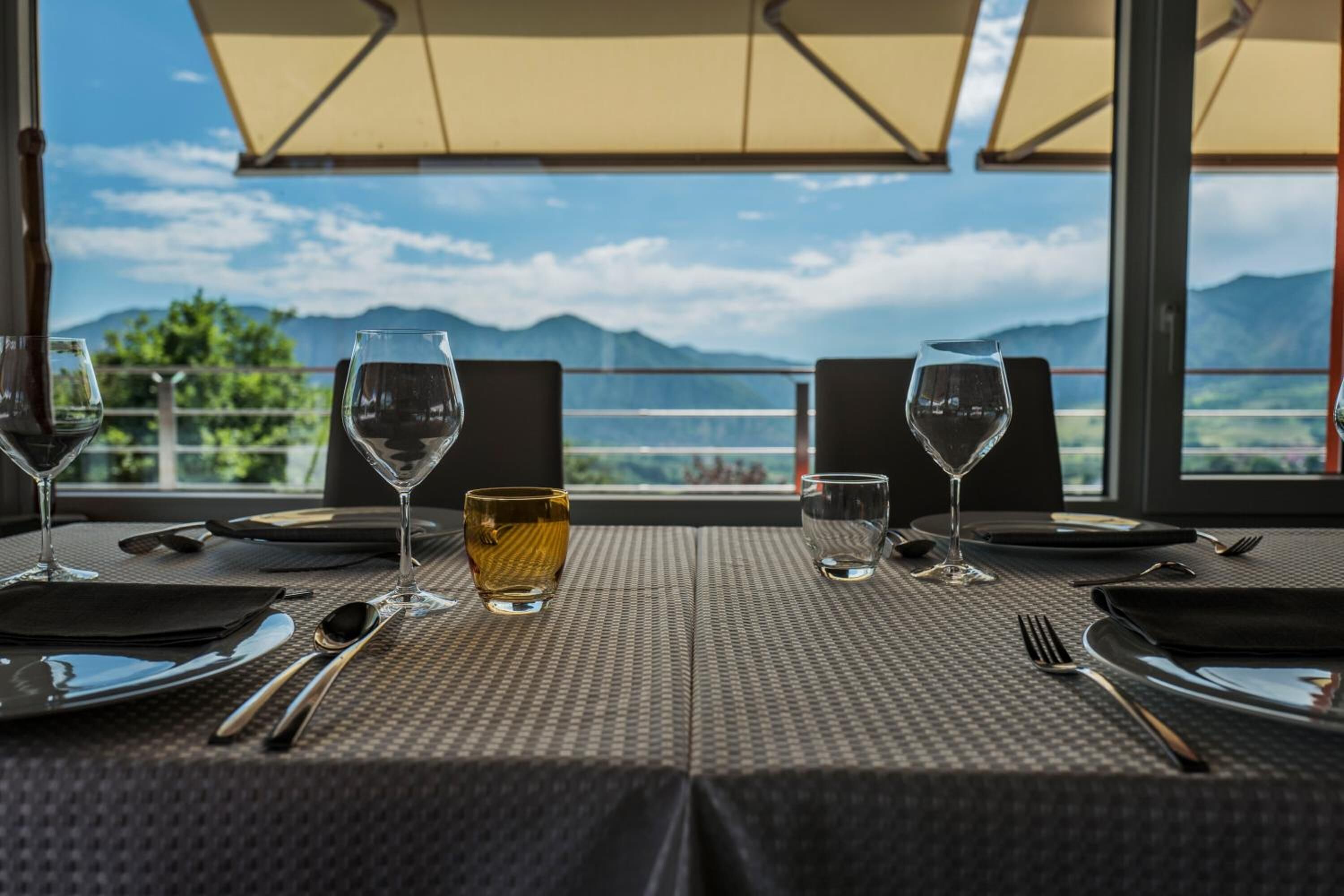 A table set for two with a view of mountains.
