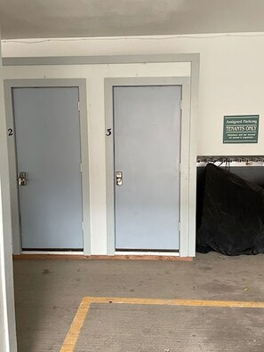 Two grey doors with numbers 2 and 3, a sign indicating assigned parking for tenants only, and a black object on the floor. - Ski. Après. Repeat. | Prime Telluride Location Steps to Gondola & Town (Telluride)